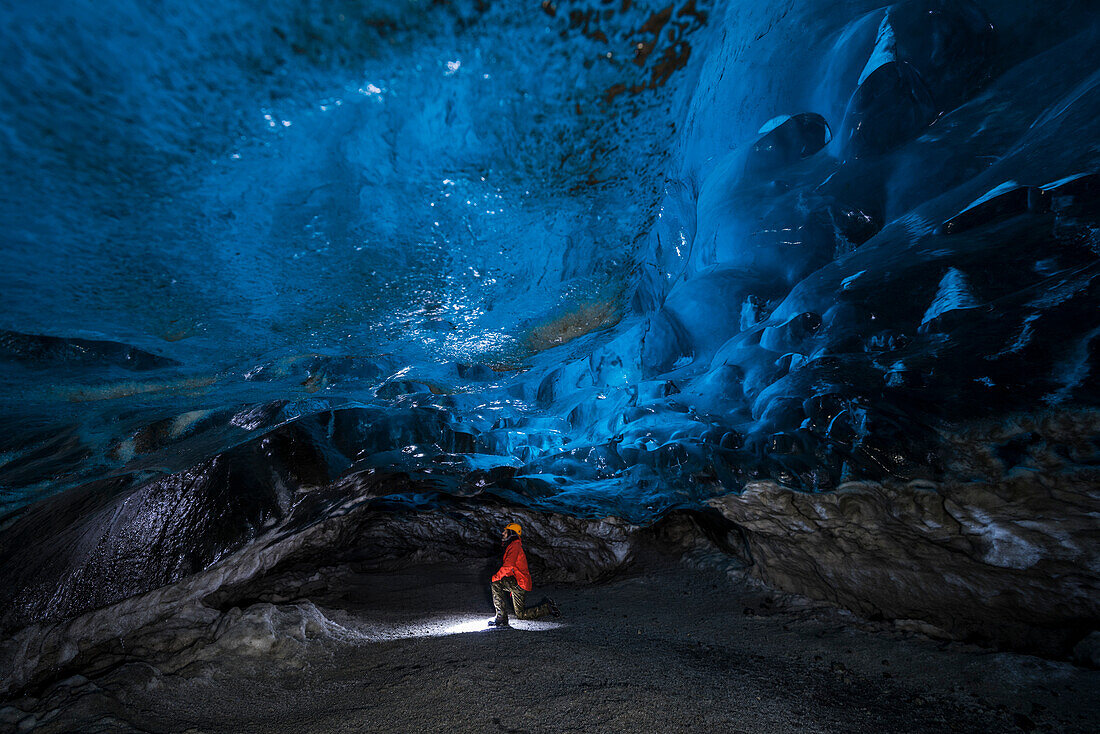 Man inside an ice caver under the Vatnajokull glacier, Vatnajokull national park, East Iceland, Iceland , MR