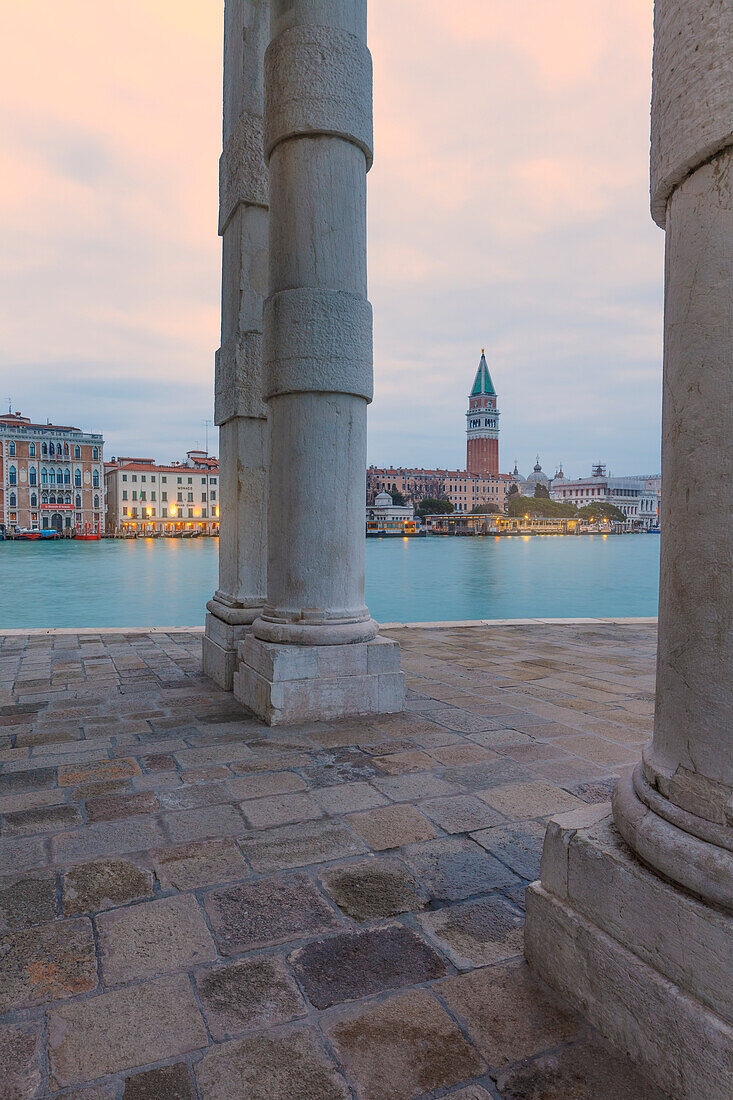 Europe, Italy, Veneto, Venice,  View of St,  Mark bell tower and buildings on the Canal Grande trough the columns of Punta della Dogana