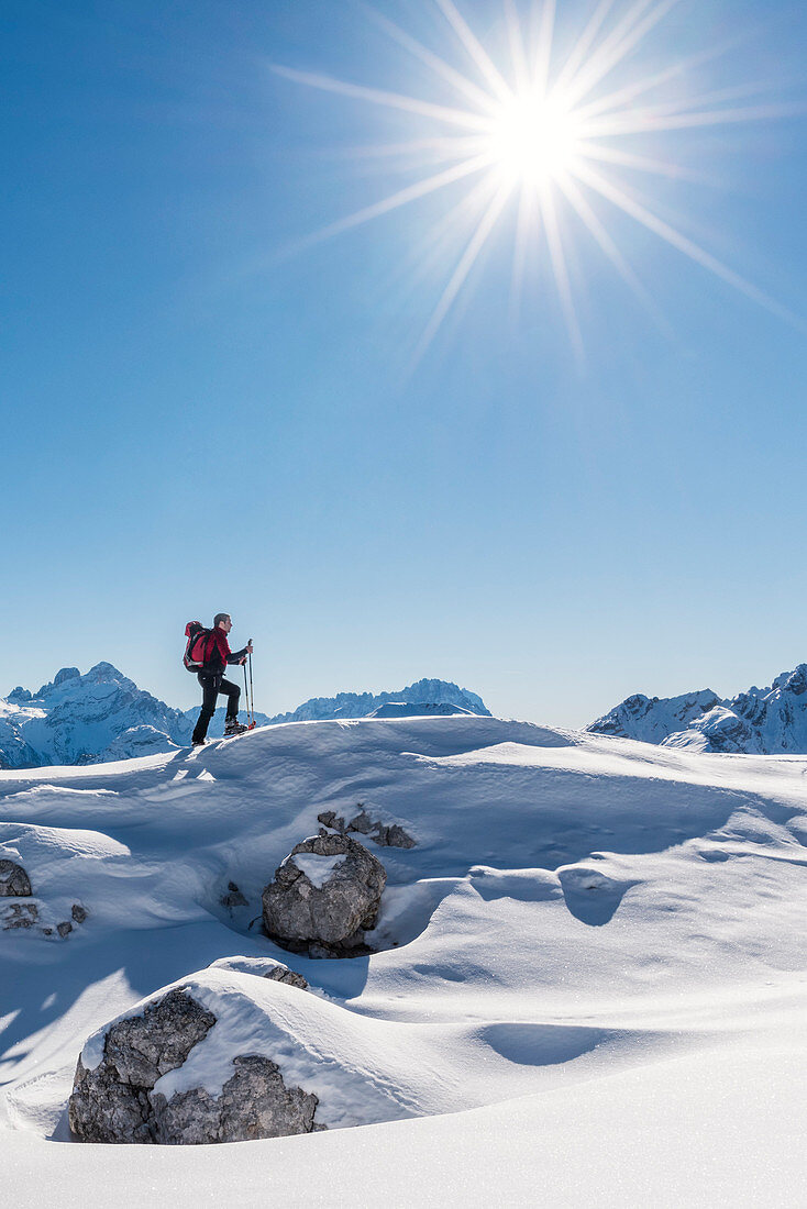 San Vigilio di Marebbe, Sennes, Dolomites, Bolzano province, South Tyrol, Italy,  A view of a hiker going up a hill with snowshoes