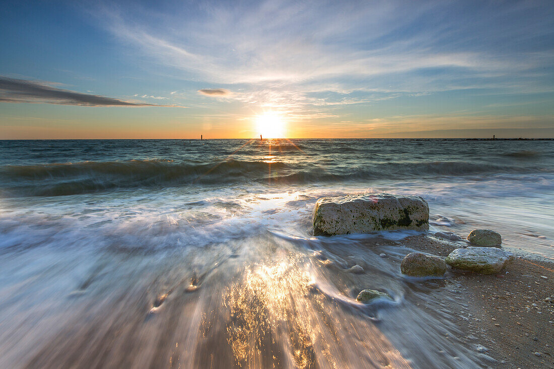 Waves crashing on the sandy beach framed by sunrise Porto Recanati Province of Macerata Conero Riviera Marche Italy Europe