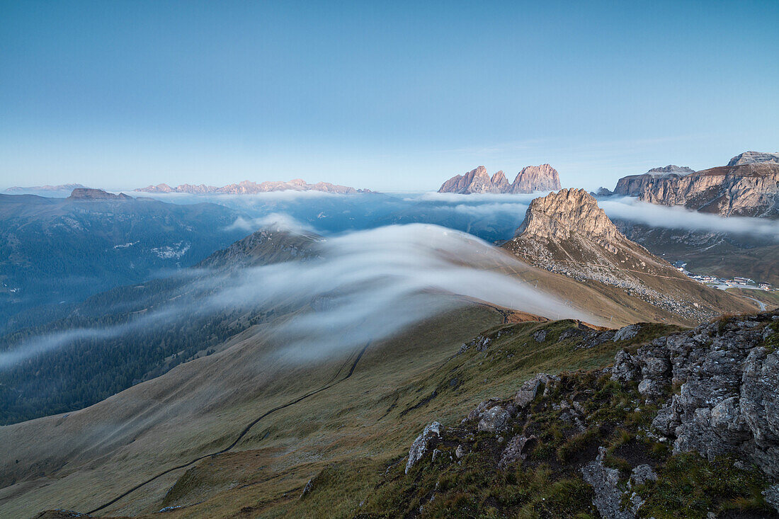 Sass Becè and Sassolungo shrouded in morning fog at dawn Cima Belvedere Canazei Val di Fassa Trentino Alto Adige Italy Europe