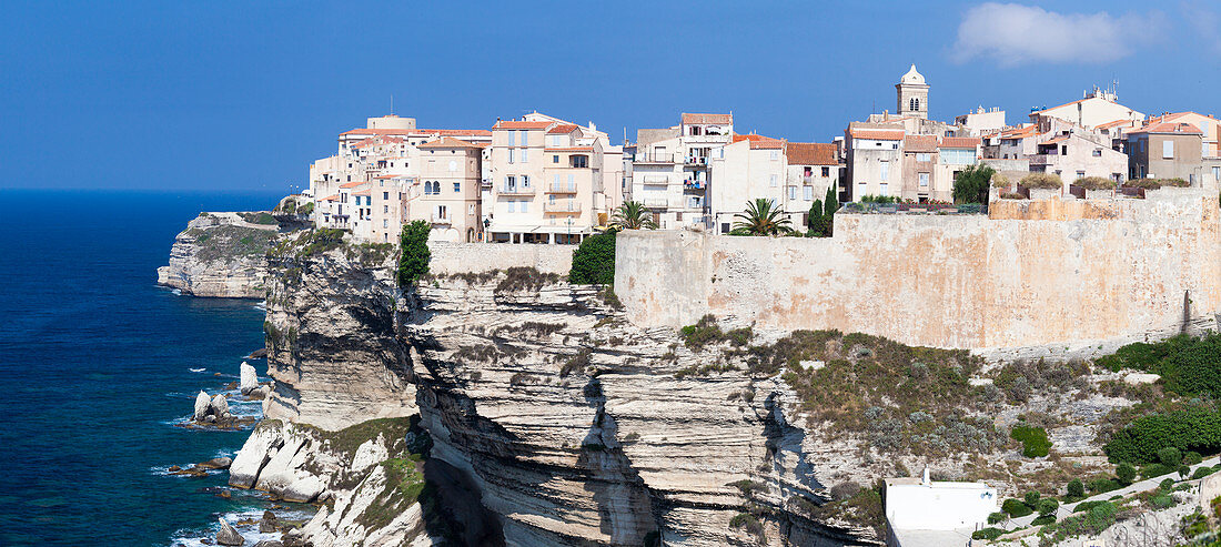 Panorama of the medieval old town and fortress perched on top of cliffs framed by the blue sea Bonifacio Corsica France Europe