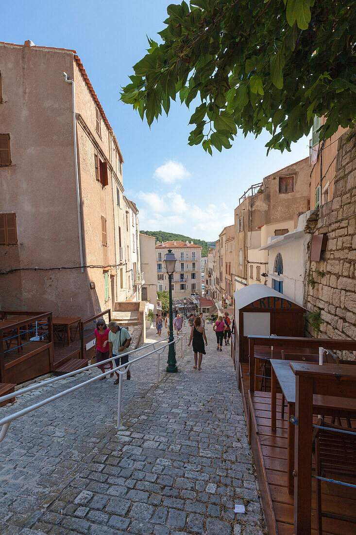 Tourists in the medieval alleys of the old town Bonifacio Corsica France Europe