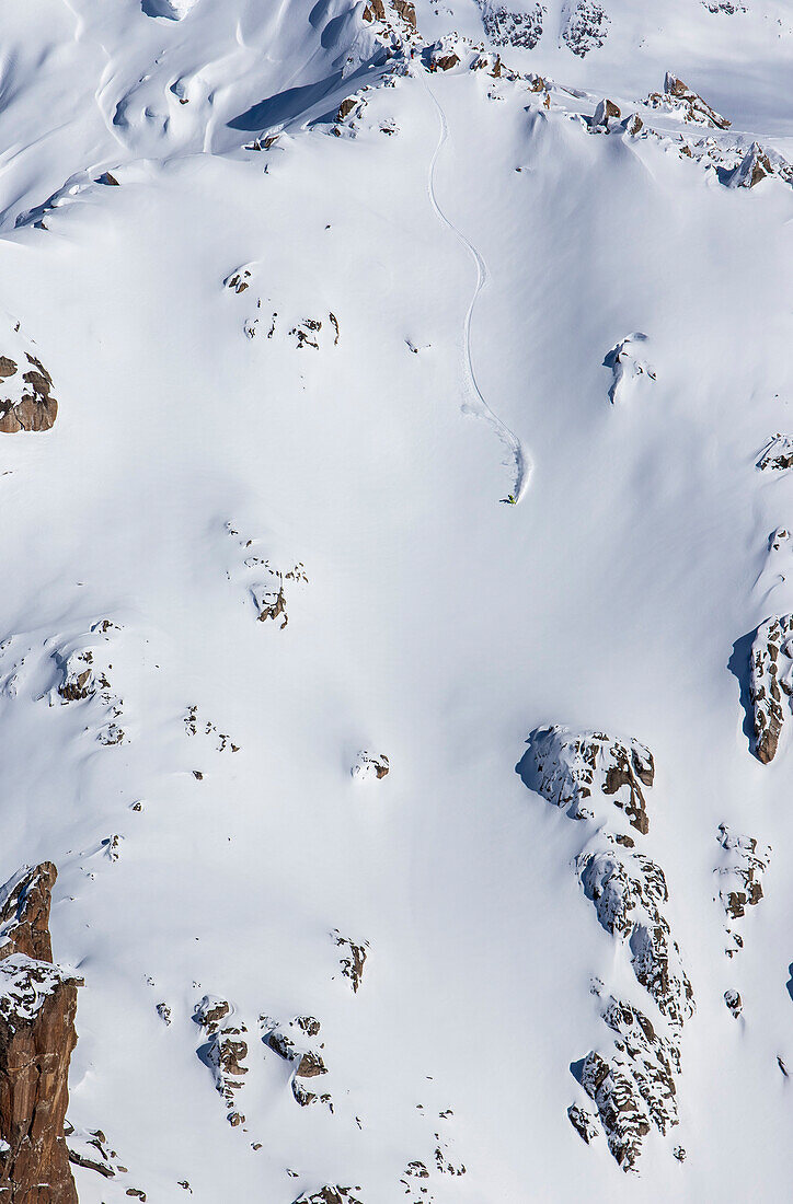 Distant View Of A Professional Skier Lucas Swieykowski Skiing At A Big Mountain Line And Gets Fresh Tracks After Ski Touring