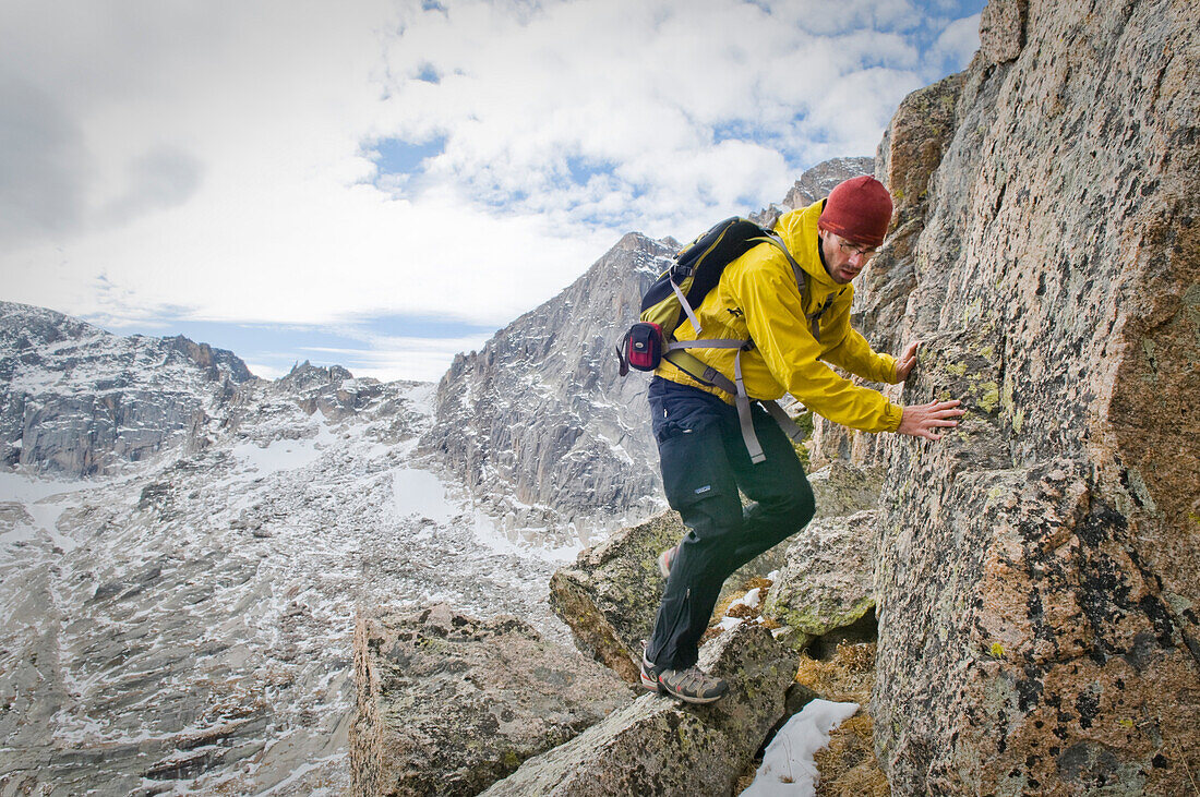 Scott Upton traverses the knife-edge ridge between Arrowhead Peak and McHenrys Peak. Rocky Mountain National Park, CO.