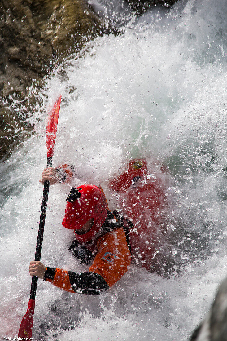 Close-up Of A Lone Kayaker Caught Up In A Swirl Of Rushing White Water