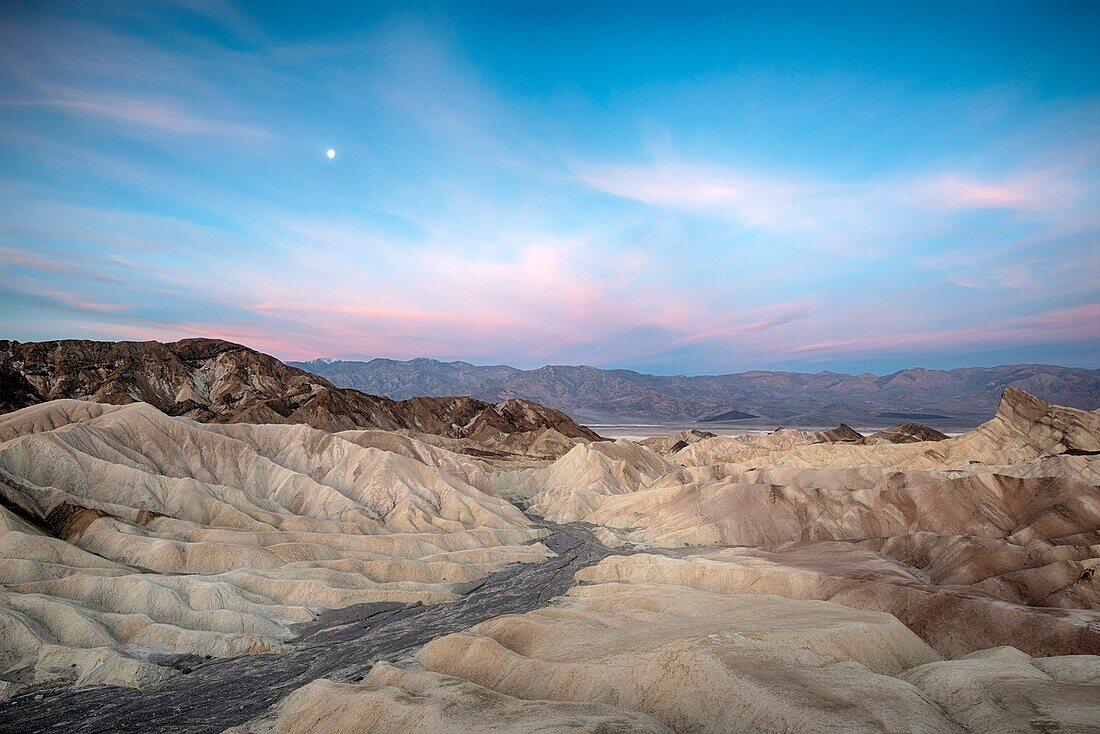 Dawn breaking over the badlands of Death Valley, as viewed from Zabriskie Point, Death Valley National Park