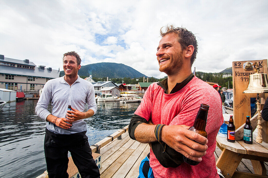 Team Members Enjoying Beer On Dock During The Race To Alaska