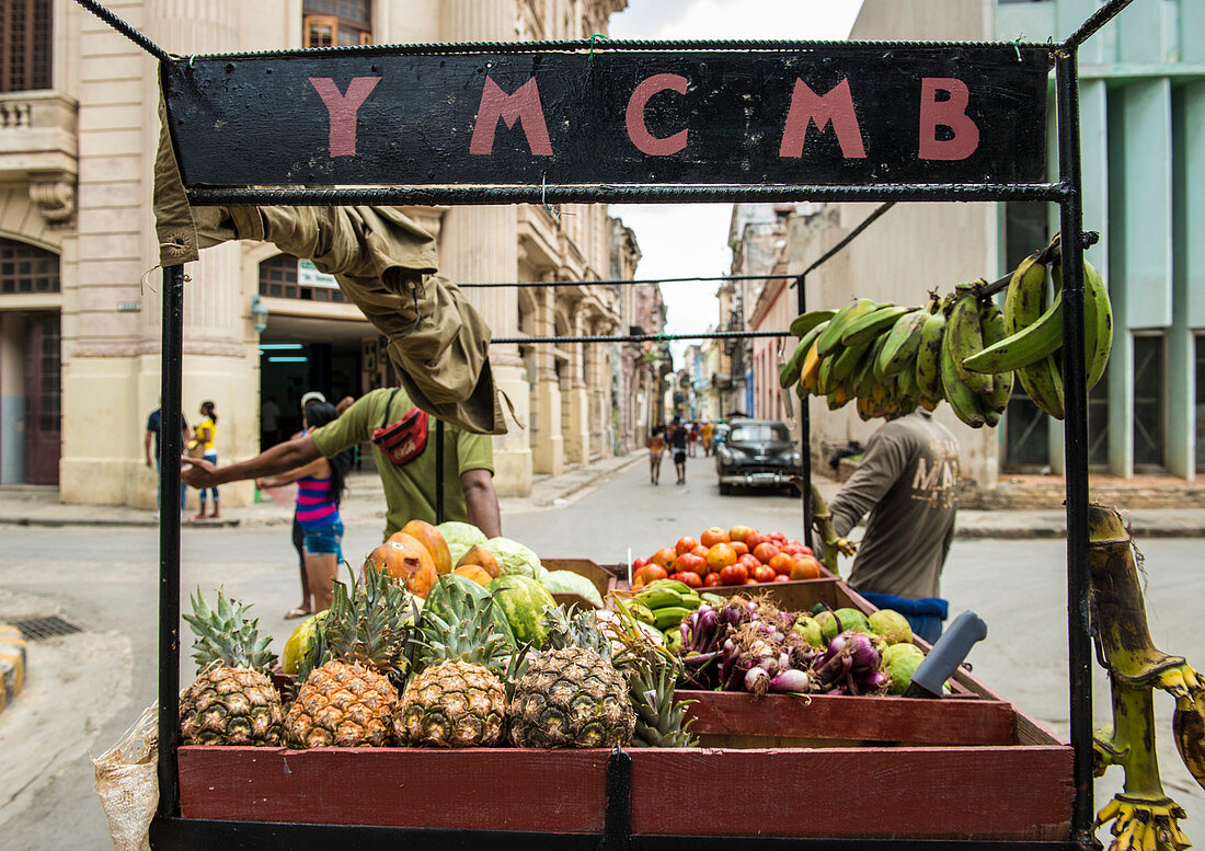 'Two men pull a fruit cart down a street in Old Havana. The sign above the cart reads YMCMB''.  La Habana Veija, La Habana, Cuba'''