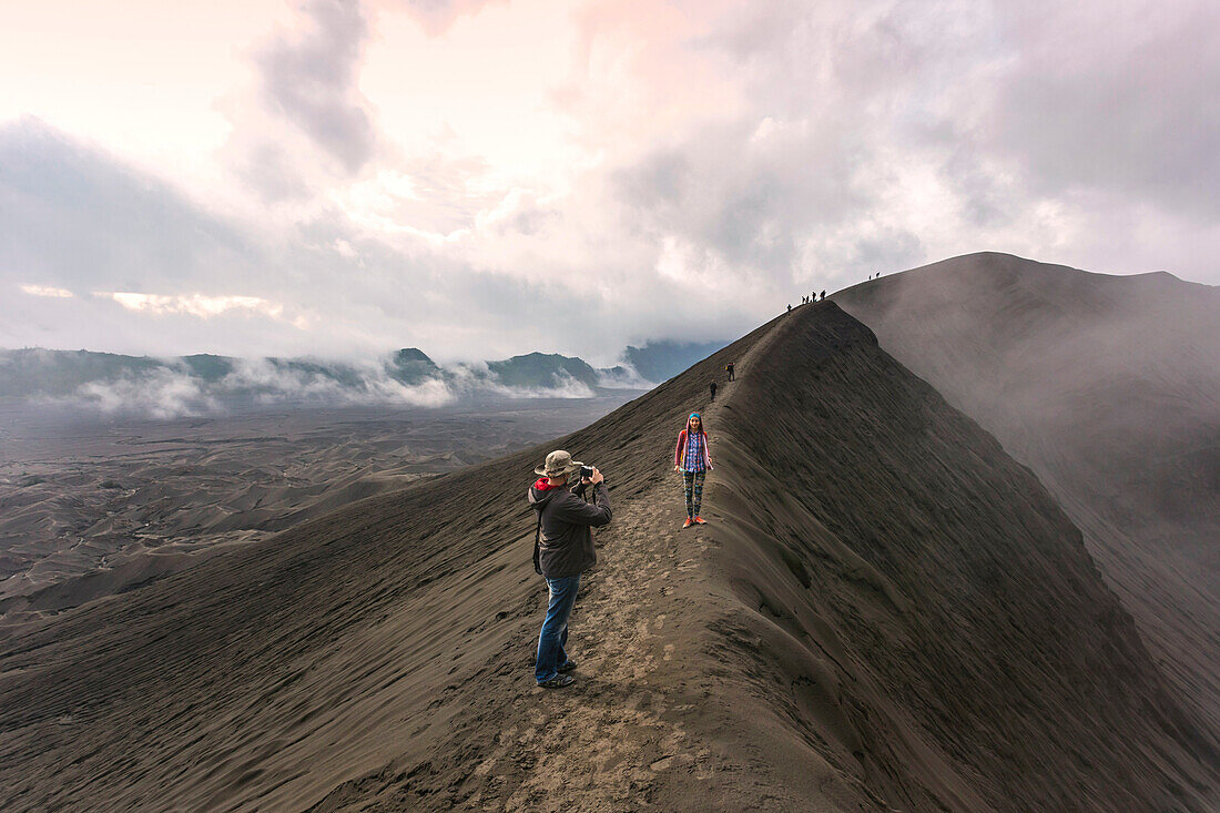 Hikers Taking Picture Standing On Top Of Mountain Near Geothermal