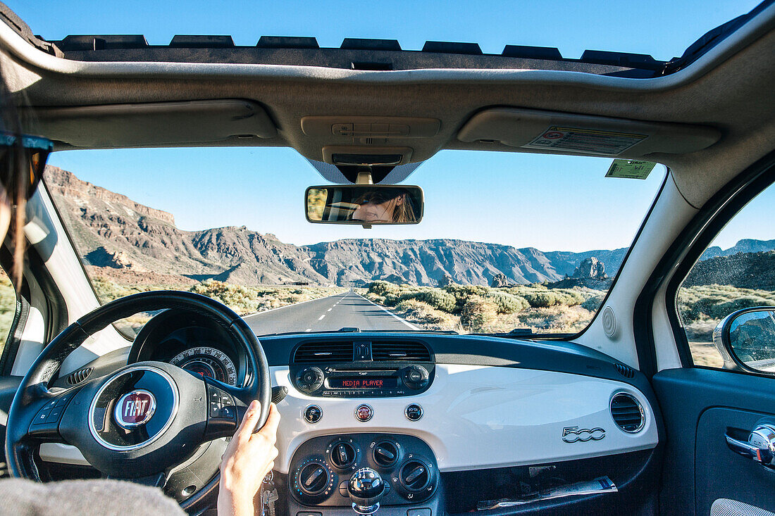 View from within a car driving on a mountain road