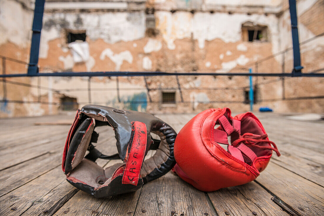 Two head protectors sit side-by-side on the makeshift wooden boxing ring at Project Cuba Boxeo, an aid project from Malaika Aid for Children, the creation of Samuel 'Sammy' Fabbri. The organization brings boxing to Cuban children from 8-21 years of age. T