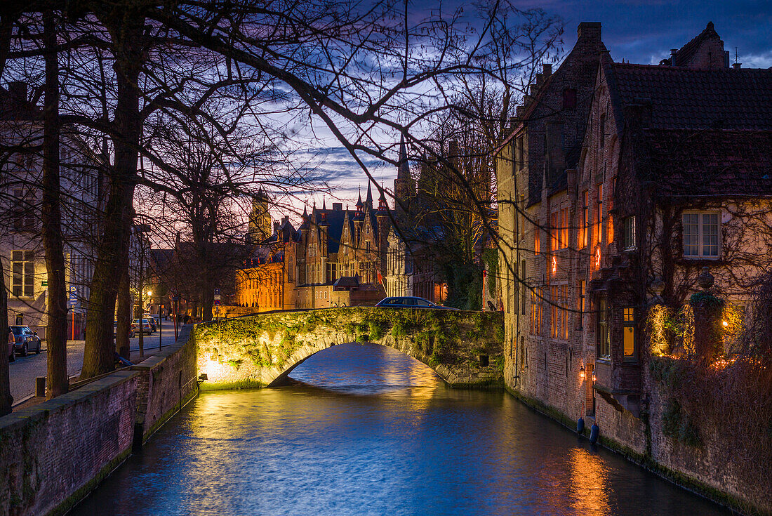 Belgium, Bruges, canalside buildings, dusk.