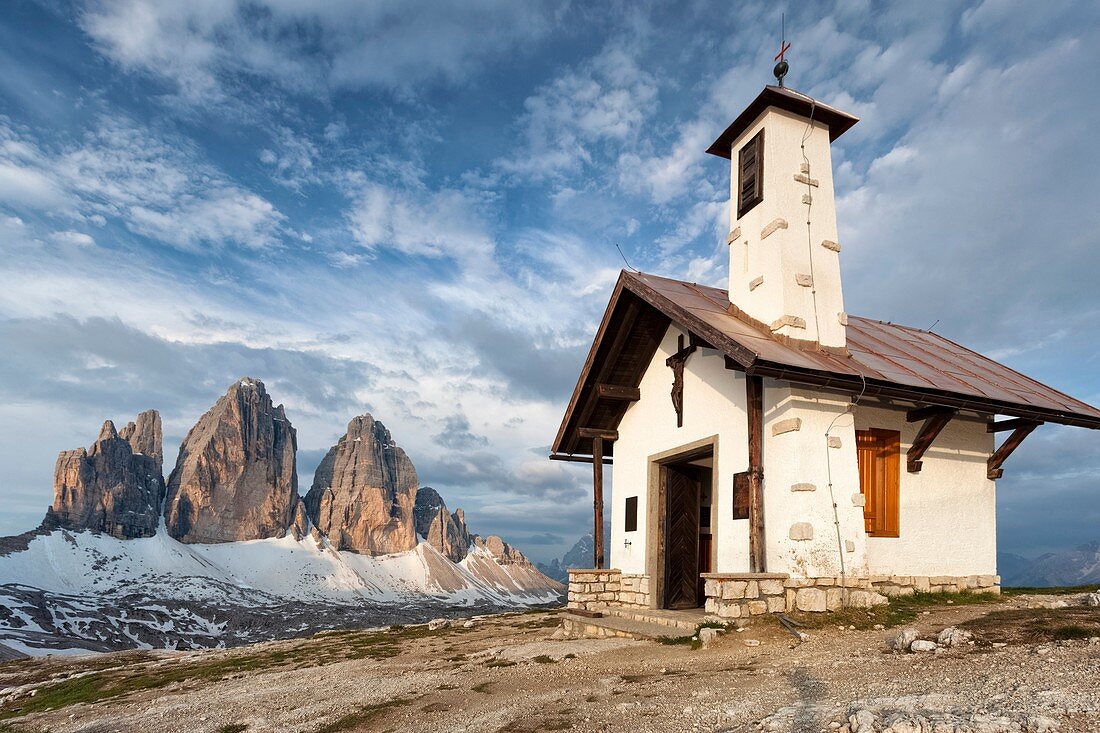 The alpine church near the refuge Locatelli In the background the Three Peaks under a blue sky Europe, Italy, South Tyrol, Bolzano, Dolomites