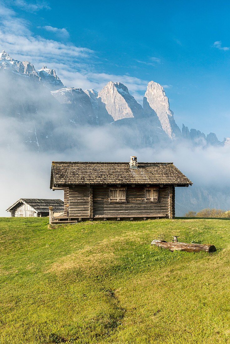 Passo Gardena, Dolomites, South Tyrol, Italy Mountain hut in front of the mountains of the Sella group