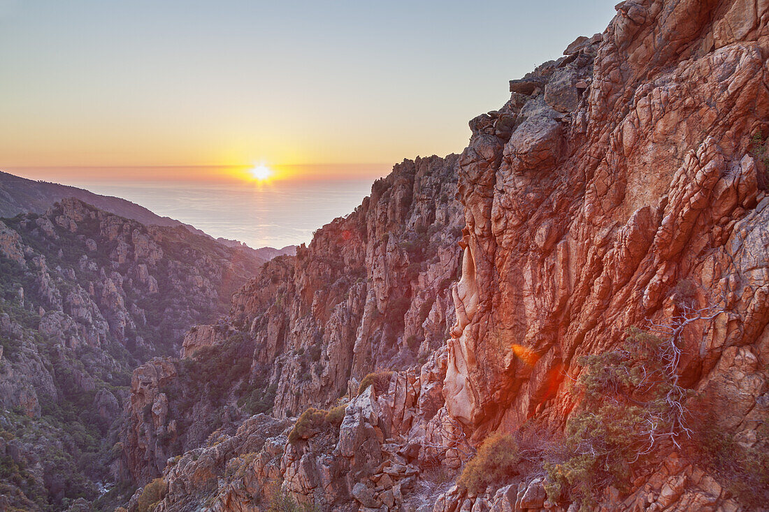 Sunset over the sea in the Calanche, west coast between Porto and Piana, West Corsica, Corsica, Southern France, France, Southern Europe, Europe