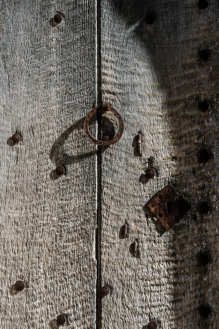 The old front door of wood with metal fittings of an old house in the village, Valldemossa, Mallorca, Spain