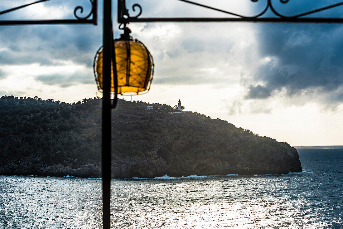 View at the port entrance with the old lighthouse from a terrace, Port de Sóller, Mallorca, Spain