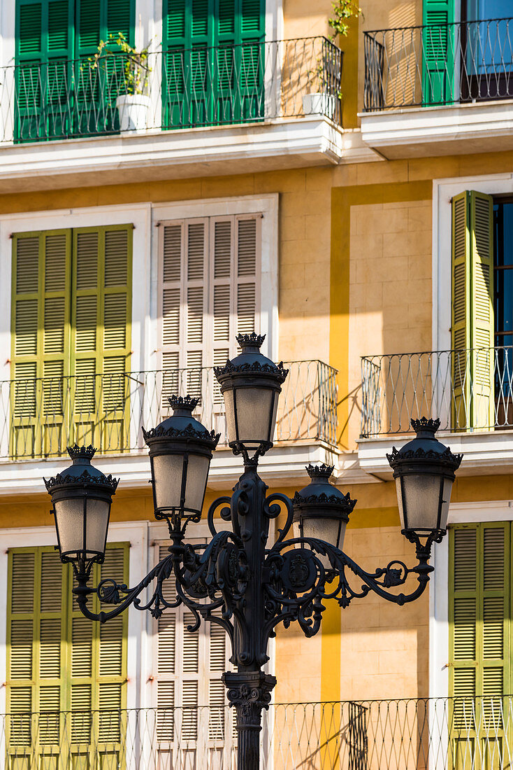 Homes with old street lamp in the public place Placa major in the old town, Palma de Mallorca, Mallorca, Spain