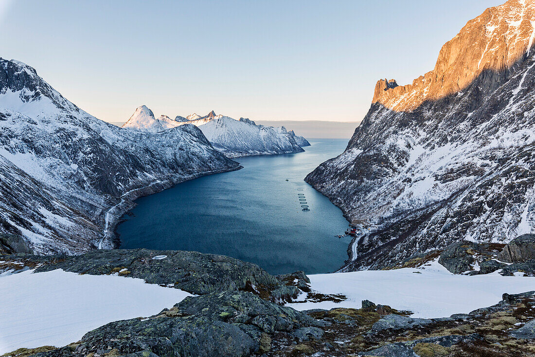 Panorama of peaks of the Ornfjorden framing the village of Fjordgard and Mount Segla in background, Senja, Troms, Norway, Scandinavia, Europe