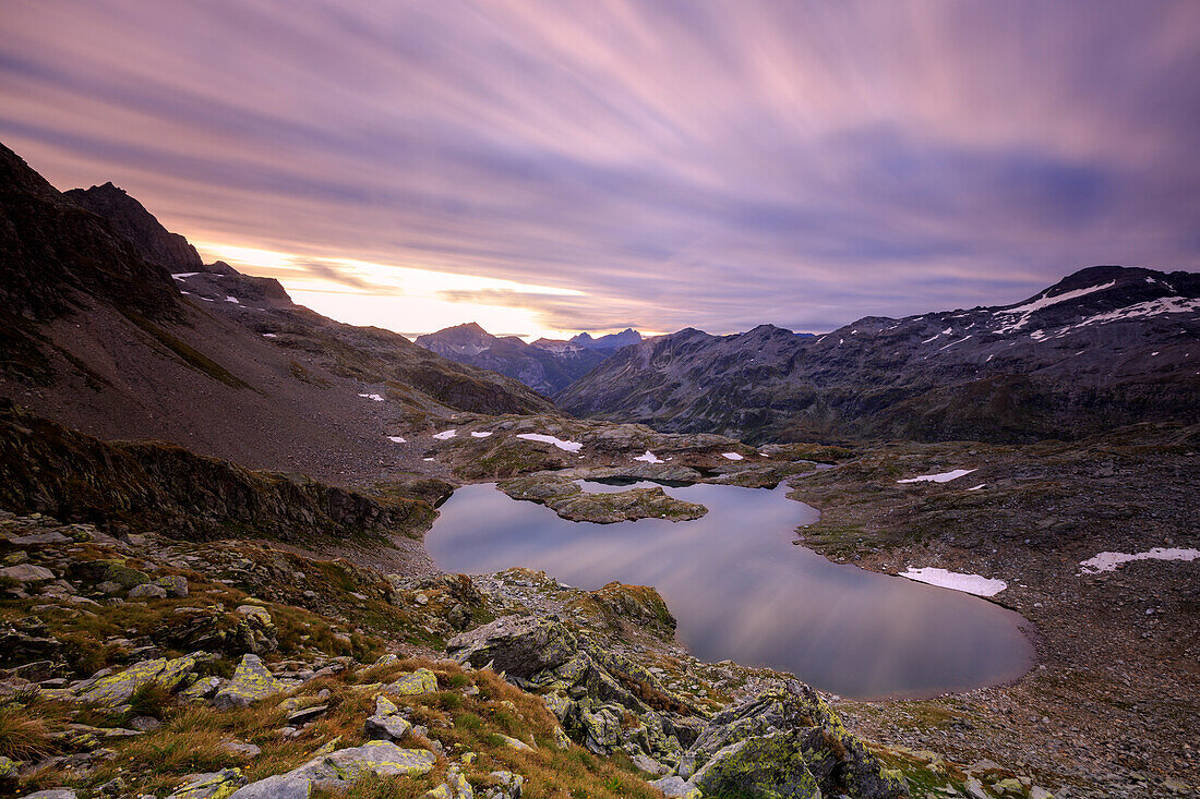 Feuriger Himmel im Morgengrauen spiegelt sich in Lai Ghiacciato umrahmt von Gipfeln, Val Ursaregls, Chiavenna-Tal, Valtellina, Lombardei, Italien, Europa