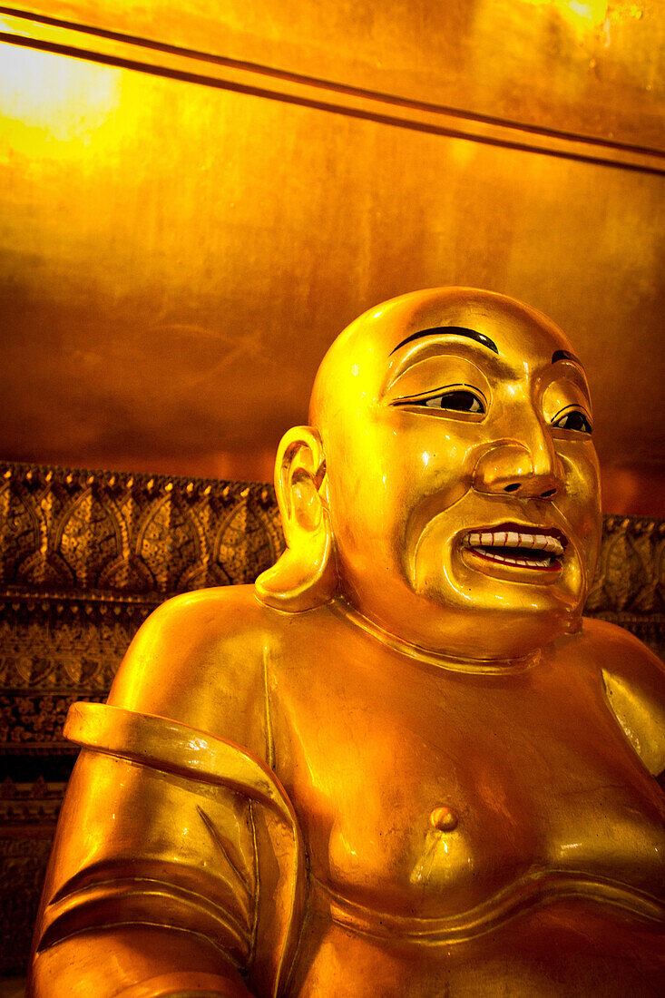 A Smiling Buddha inside Wat Pho (Wat Po), Bangkok, Thailand, Southeast Asia, Asia
