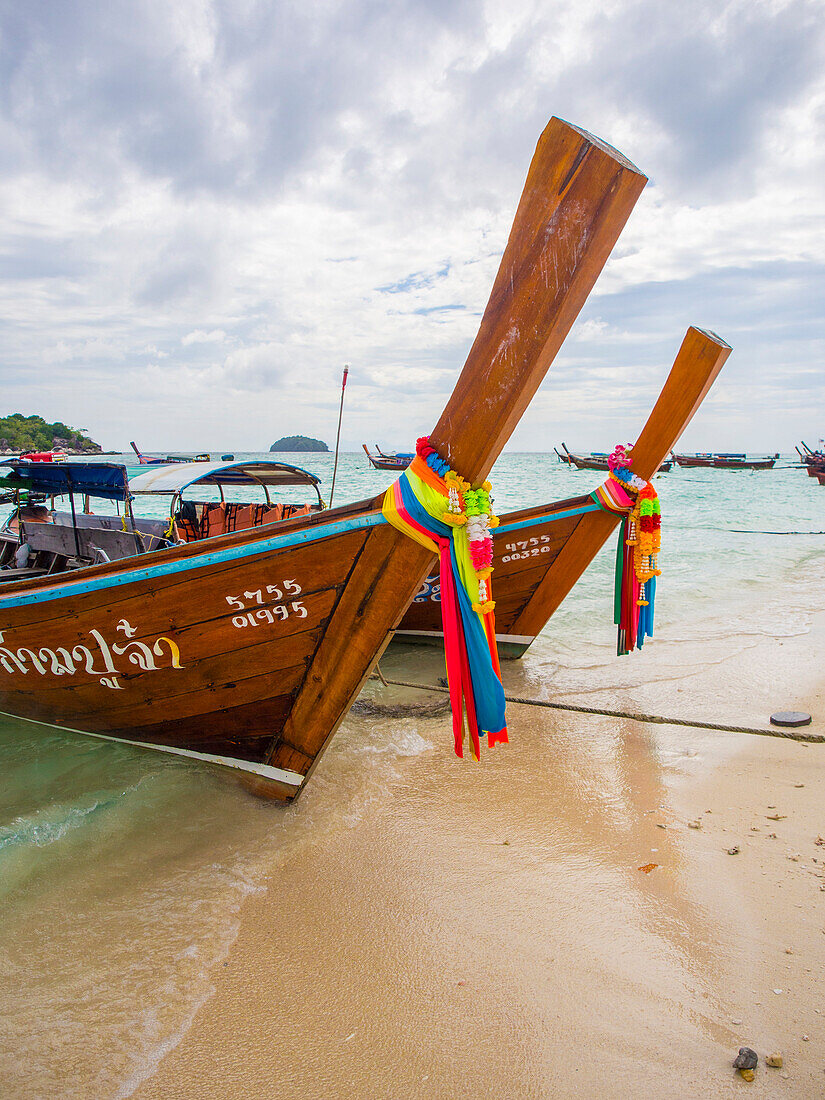 Long-tail boats with coloured-ribbon offerings, Ko Lipe, Thailand, Southeast Asia, Asia