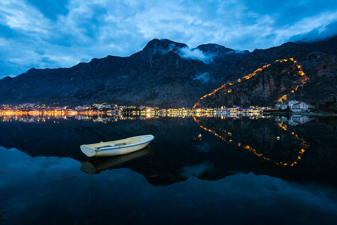 The Old Town (stari grad) and fortress of Kotor reflected in Kotor Bay, UNESCO World Heritage Site, Montenegro, Europe