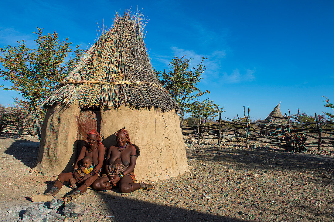 Himba women in front of their hut, Kaokoland, Namibia, Africa