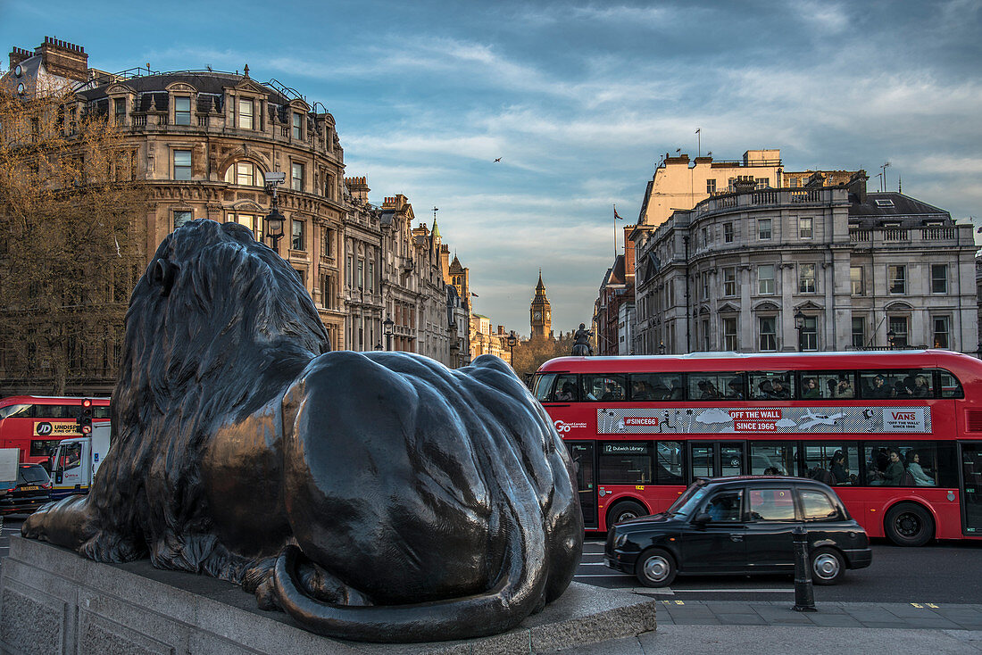 Landseer lion statue and double decker bus, London icons at Trafalgar Square, London, England, United Kingdom, Europe