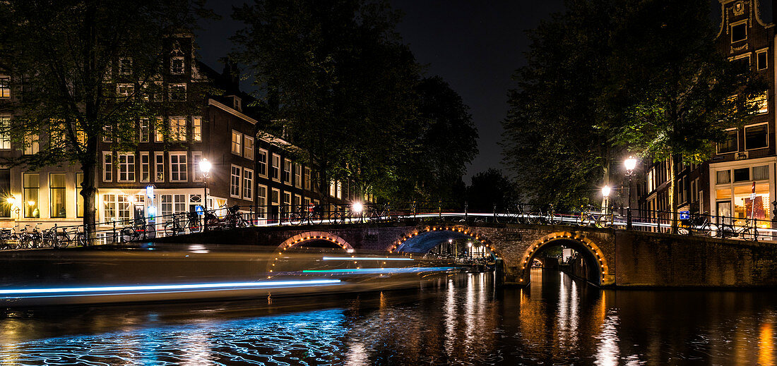 Amsterdam, the Netherlands, Europe, Canal and light trails of a boat