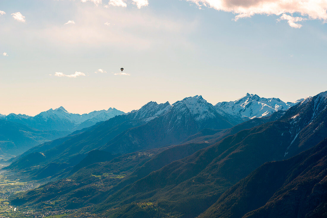 hot air balloon flies over Aosta city, Valle d'Aosta, Italy, Europe