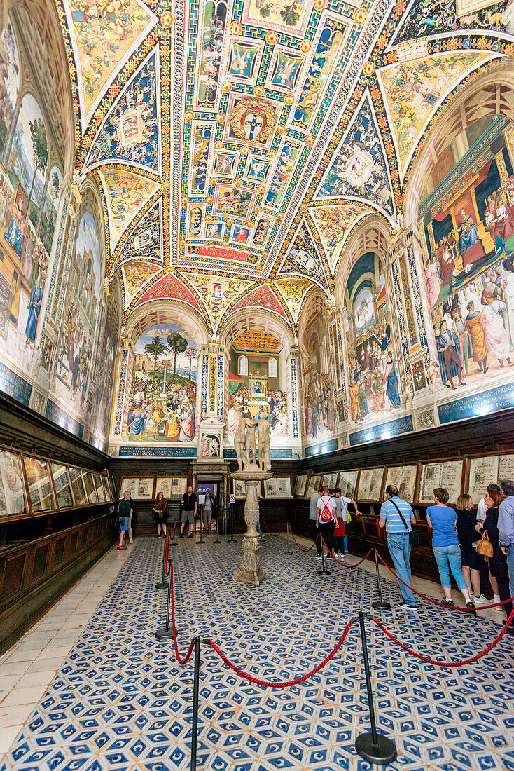 Tourists inside the Piccolomini Library of Siena Cathedral, Europe, Italy, Tuscany, Siena