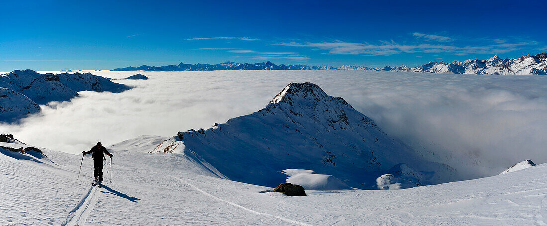 Ski Bergsteiger mit Meer von Wolken, Trécare peack, Valtournenche, Aostatal, Italien
