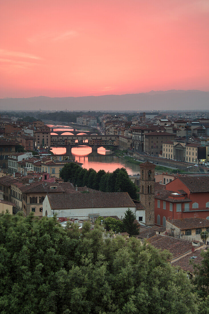 Pink sunset on the Arno River and Ponte Vecchio seen from Piazzale Michelangelo Florence Tuscany Italy Europe