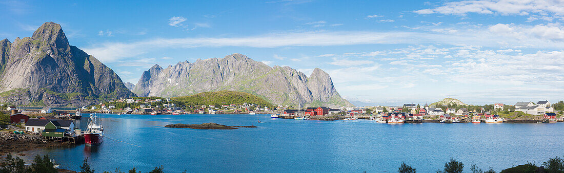 Panorama of the blue sea surrounding the fishing village and rocky peaks Reine Moskenes Lofoten Islands Norway Europe