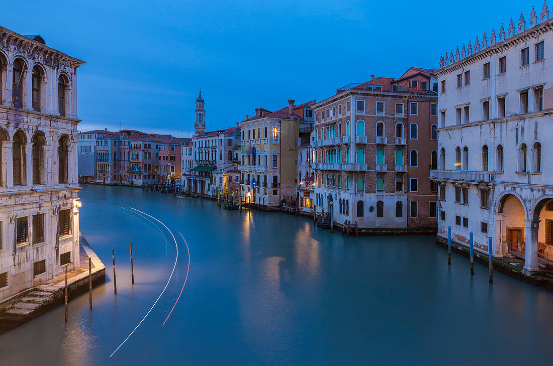 Dusk lights on the Canal Grande surrounded by historical buildings and houses Venice Veneto Italy Europe