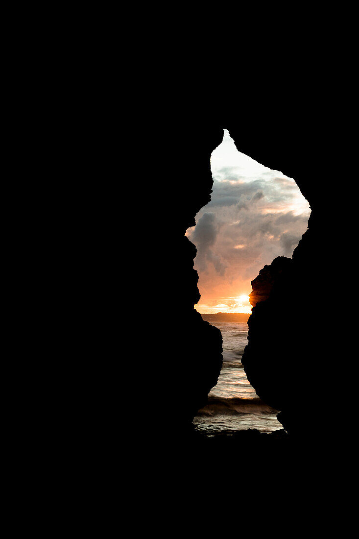 View of the sunset sky from a sea cave Praia Dos Tres Irmaos Portimao Algarve Portugal Europe