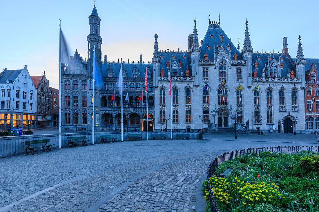 Blue lights of dusk on the gothic palace of the Provinciaal Hof in Market Square Bruges West Flanders Belgium Europe