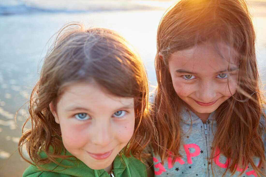 Portrait of two 8 year old girls smiling,  roche beach, andalusia, southwest coast spain, atlantc, Europe