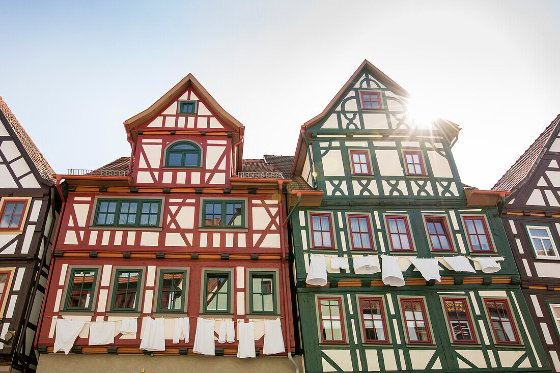 Red and green historic half-timbered house with laundry lines, Schmalkalden, Thuringia, Germany, Europe