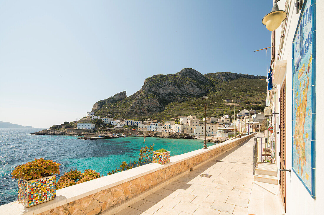 White esplanade and buildings in the harbor city of Levanzo, Levanzo Island, Aegadian Islands, near Trapani, Sicily, Italy, Europe