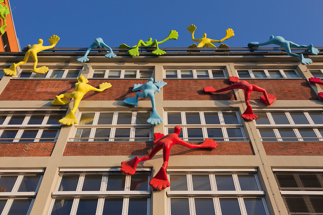 Flossi figures at the facade of the Roggendorf house, Medienhafen, Duesseldorf, North Rhine-Westphalia, Germany