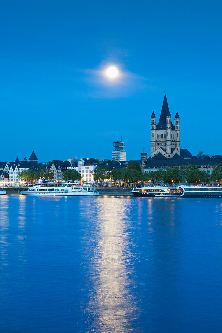 Full moon, view over the Rhine river to the Old town with Gross-St-Martin, Cologne, North Rhine-Westphalia, Germany