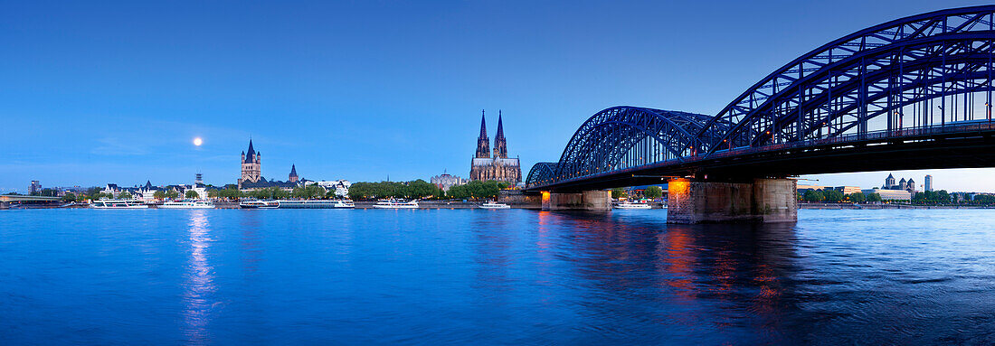 Full moon, panoramic view over the Rhine river to the Old town with Gross-St. martin, Museum Ludwig, cathedral and Hohenzollern bridge, Cologne, North Rhine-Westphalia, Germany