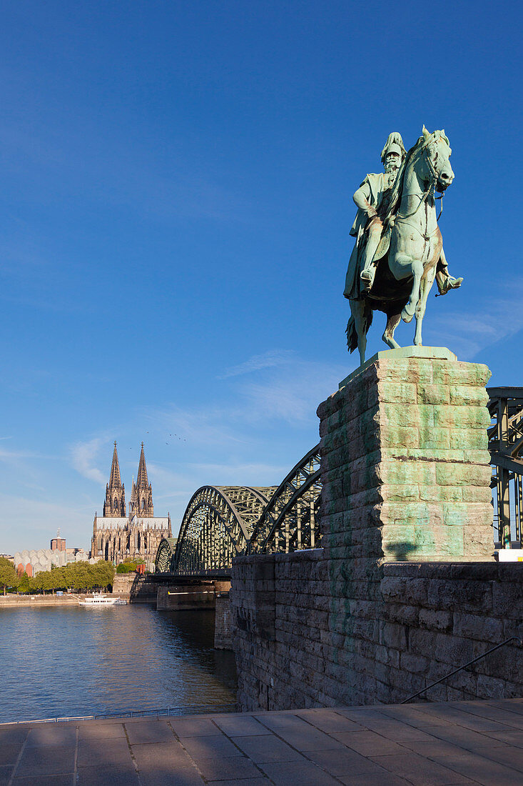 Equestrian sculpture at Hohenzollern bridge, view over the Rhine river to Museum Ludwig and Cologne cathedral, Cologne, North Rhine-Westphalia, Germany