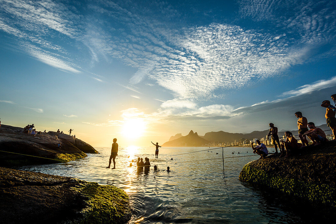 Slacklining In Arpoador Beach During The Sunset, Rio De Janeiro, Brazil