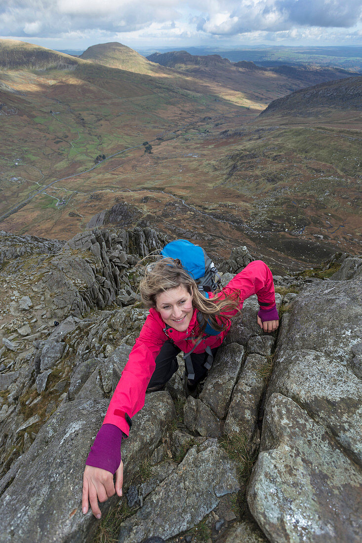 Female hiker arrives at mountain summit