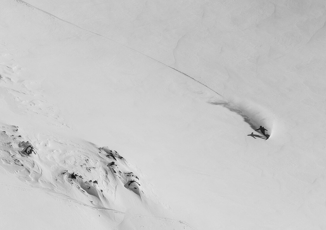 A Snowboarder Rides On Fresh Snowy Slope In The Backcountry Around Cerro Catedral In Argentina