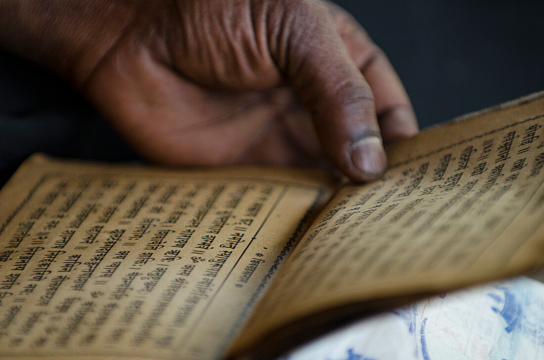 Hindu man reading ancient scripturesÂ IndreshwarÂ MahadevÂ Temple in city ofÂ Panaut
